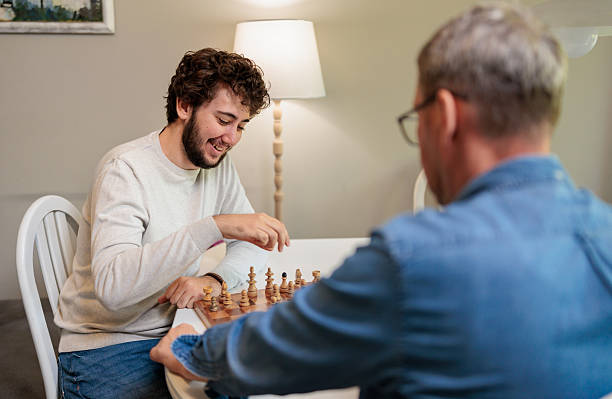 istock Chess match between father and son in a cozy living room setting 2222219454