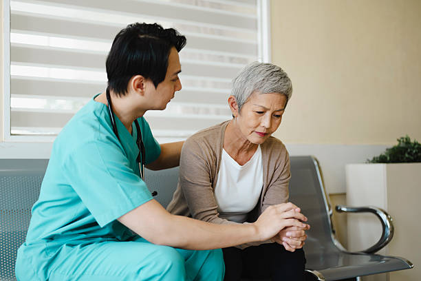 istock Doctor Offering Emotional Support to Elderly Patient in Corridor. 2222222524