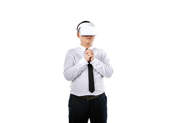 Businessman wearing virtual reality glasses hands clasped together in prayer