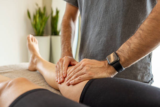 istock Physiotherapist Treating Patient's Knee with Massage Therapy 2222223197