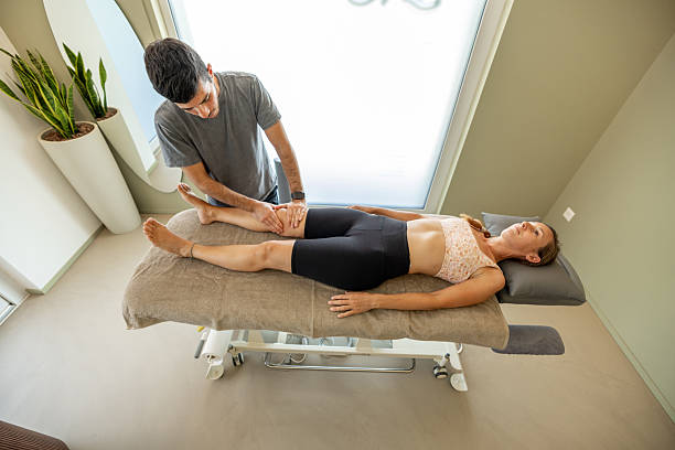 istock Physiotherapist Treating Patient's Knee with Massage Therapy 2222223307
