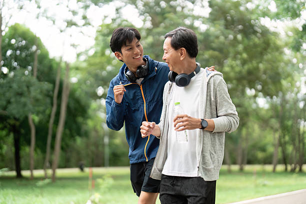 istock Father and Son Wellness Journey. Active bonding through exercise in a green park. 2222225890
