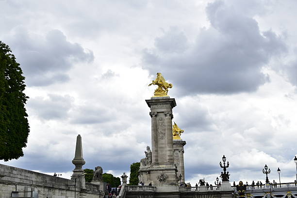 An impressive statue depicting a man riding a magnificent horse, beautifully positioned atop a strong pillar that rises high into the sky