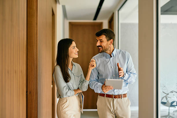 istock Business partners walking and talking in office hallway 2222230817