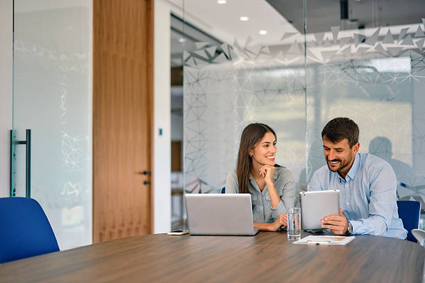 istock Business partners working together in modern office using laptop and tablet 2222231002