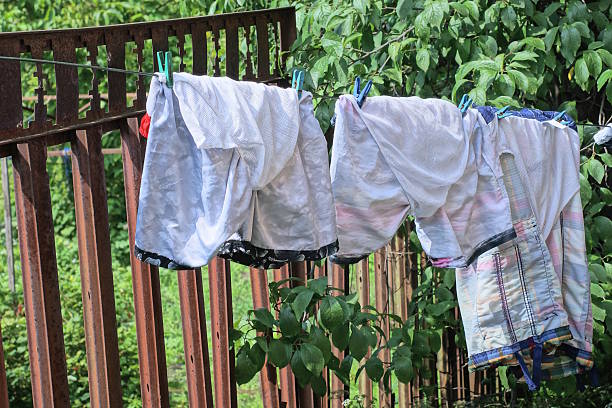 istock three white wet shorts hanging on a wire with clothespins 2222231993