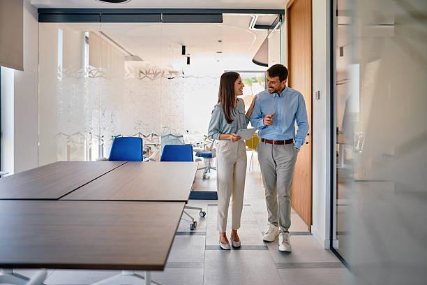 istock Business colleagues walking and talking in modern office 2222232212