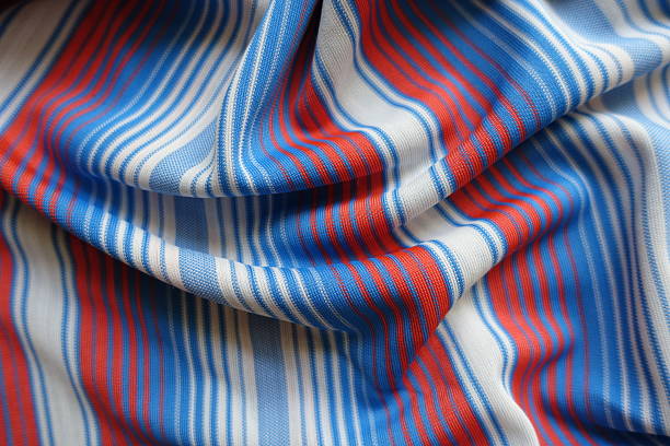 Soft folds on blue, red and white striped fabric