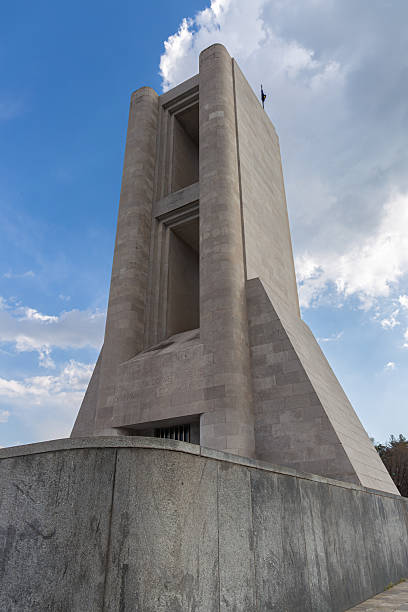 istock Large Concrete Monument Against Blue Sky With Dramatic Clouds 2222240673