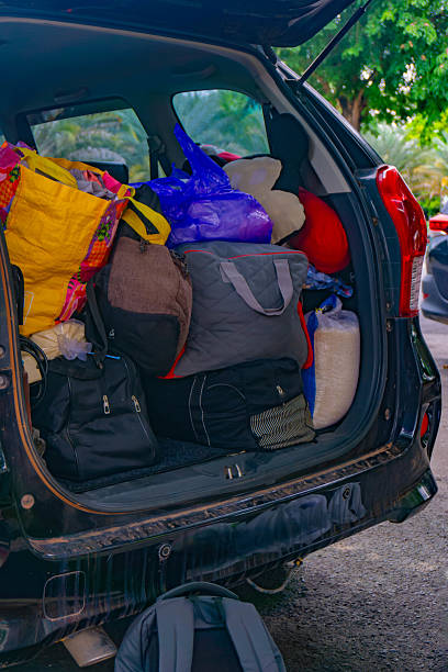 istock Car trunk packed with various bags and items in preparation for a trip 2222242459