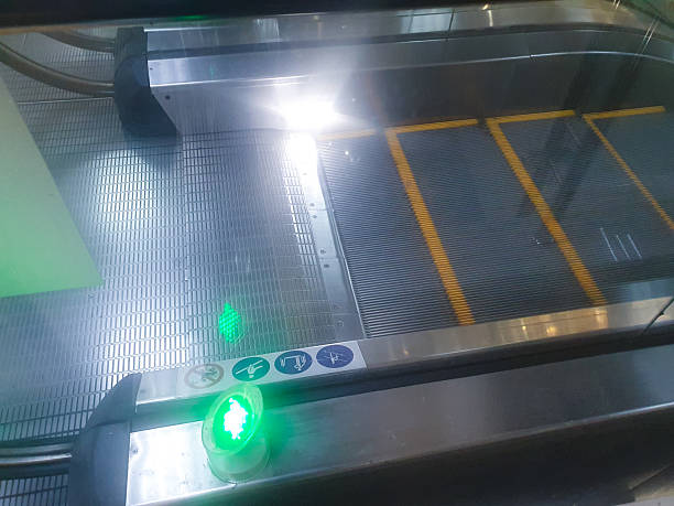 Escalator,an electric elevator in a shopping mall with a lighted arrow sign.