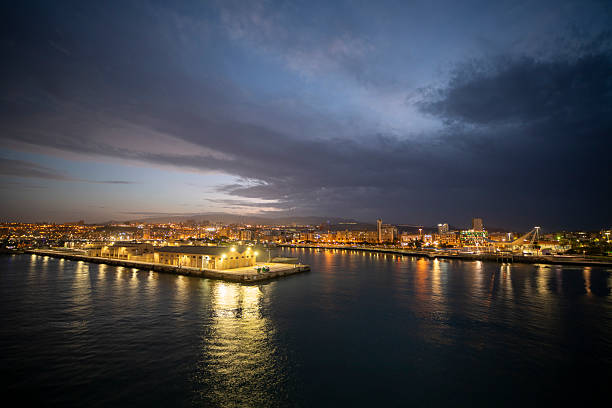 Las Palmas de Gran Canaria Canary islands Spain  Magnificent sunset over the gentle waves of the Atlantic ocean Gran Canaria island illuminated  harbour Canary islands Spain. View from a cruise ship.