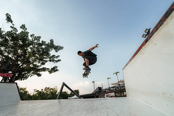 istock Young Asian man riding a skateboard and sliding down the handrail during a junior competition. 2222245697