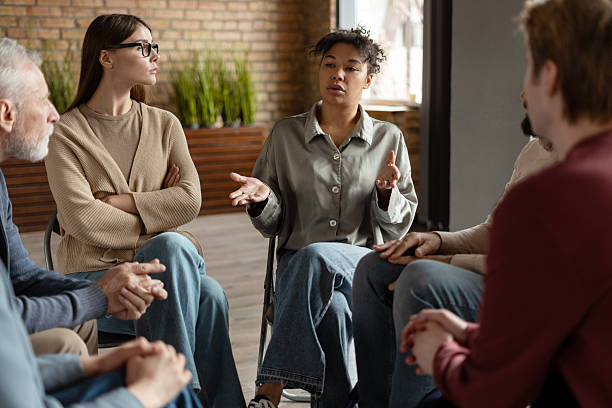 istock Patients listening to therapist during group therapy session 2222246056