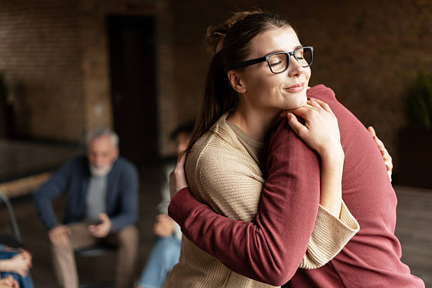 istock Young woman is hugging a man during a group therapy session 2222246141