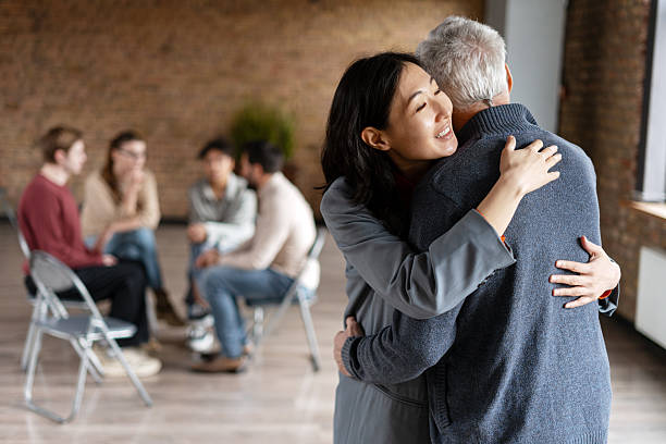 istock Daughter supporting senior father at group therapy session 2222246151
