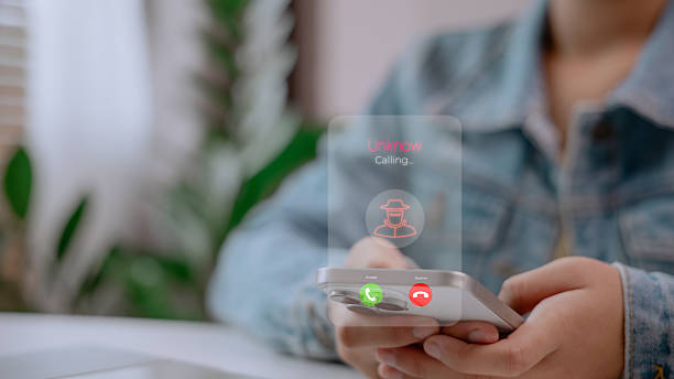 istock Incoming call from unknown number with scam icon on smartphone screen, warning about phone fraud, cyber threats, and digital safety. Concept of identity protection and scam alert system. 2222247445