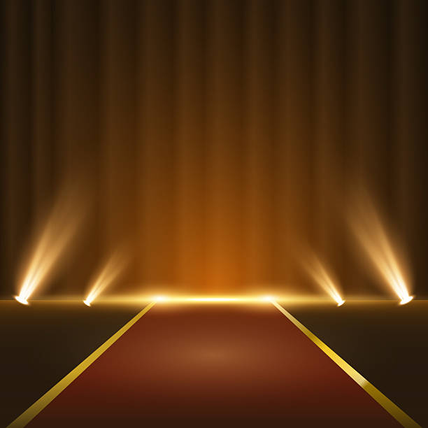 istock Golden stage with glowing spotlights and red carpet on dark background. Elegant podium illuminated by sparkling rays and festive particles, perfect for awards, ceremonies, or product showcase. 2222248125