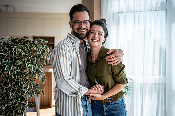 istock Happy couple embracing and smiling at home 2222248983