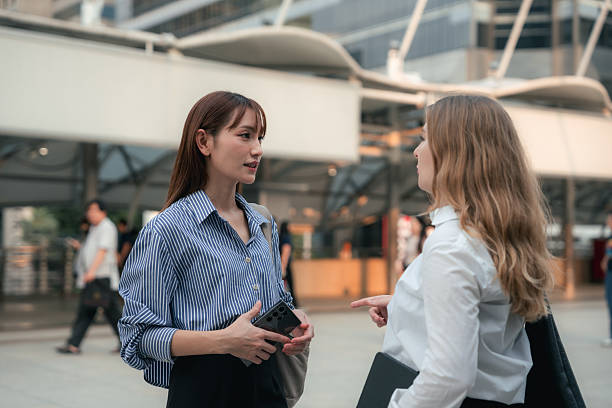 istock Two confident colleagues walking side by side toward the office, engaged in a quick morning sync-up as they discuss project updates and align on the day's priorities 2222249670