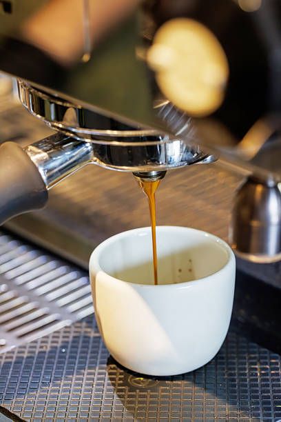 istock Coffee machine pouring fresh espresso into a cup 2222253367