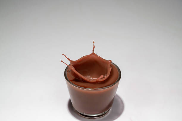 Chocolate milk drink splash and twist into glass.