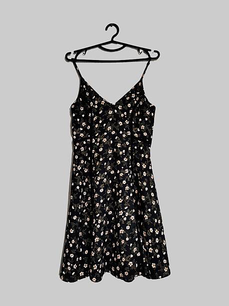 istock Black white floral print thin straps mini dress on hanging isolated on gray solid background. Botanical print fit and flare sleeveless chiffon summer sundress. Women's clothes, fashion, style, design 2222257475