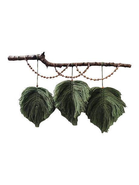 Three green macrame feathers on tree branch with beads wall hanging on white background isolated. Boho interior handmade wall decor, craft ideas, yarn decorative home decoration