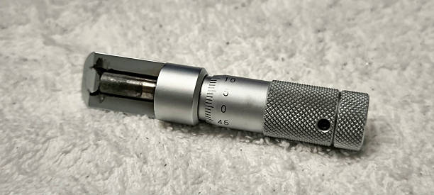 High-resolution thickness micrometer placed on white cloth Micrometer for measuring thickness placed on a white towel micrometer screw gauge stock pictures, royalty-free photos & images