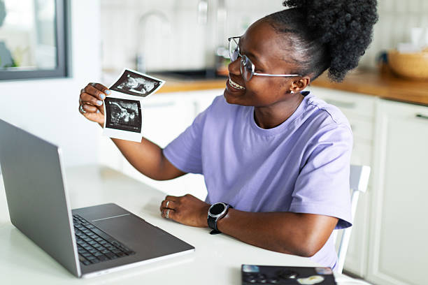 istock Showing ultrasound image to friends using laptop for video call 2222263572