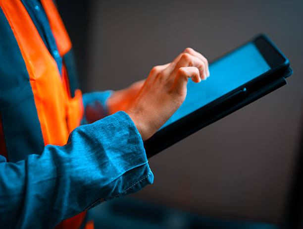 istock Worker in Logistics Using a Tablet for Warehouse Management in a Modern Facility 2222264199