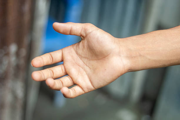 A fair-skinned boy's show his hand and background blur
