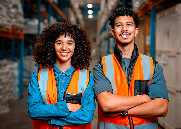 istock Two Diverse Warehouse Workers Smiling Confidently in Safety Vests inside an Organized Storage Facility 2222265258