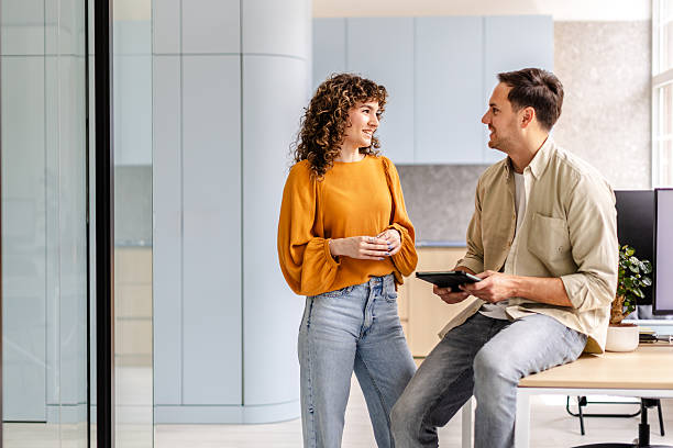 istock Discussion between colleagues in a modern office setting with bright natural light and contemporary decor 2222265336