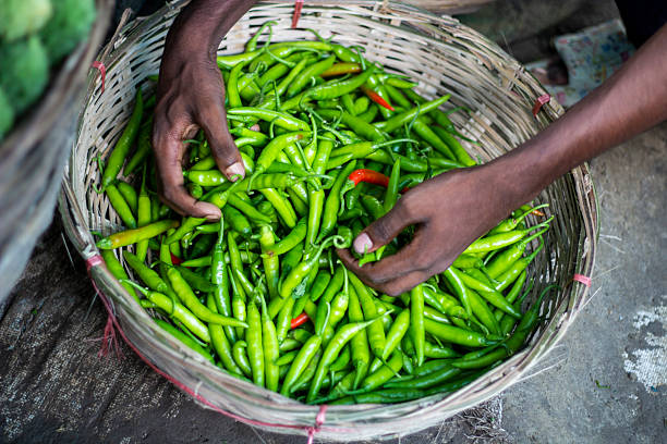 istock A young man is holding the green chilli his both hands 2222265465