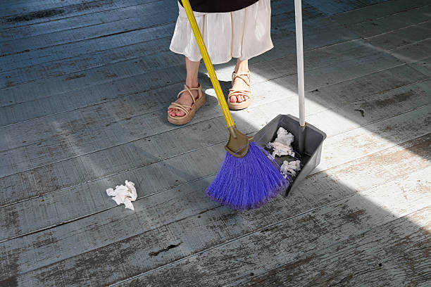 Close-Up of Sweeping Paper with Dustpan and Broom