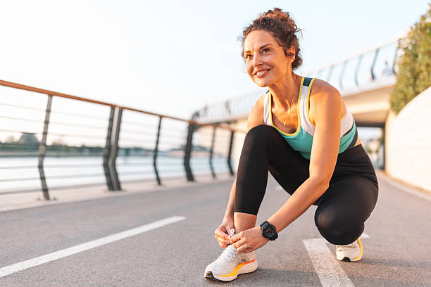istock Active Woman Tying Shoe Laces Before Running 2222267275