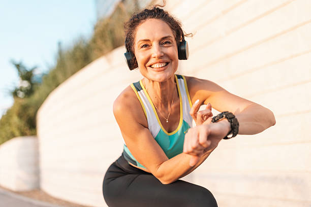 istock Cheerful Woman Checking Fitness Tracker After Workout 2222267362