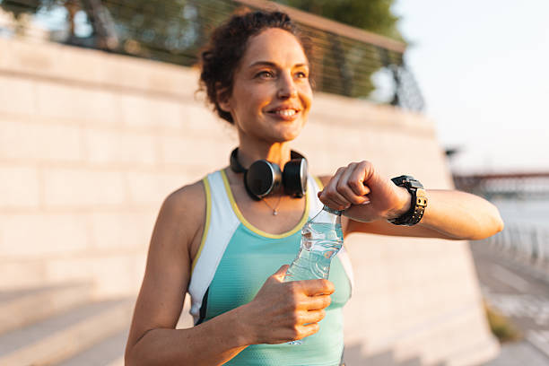 istock Fit woman checking her watch post-exercise outdoors. 2222267505