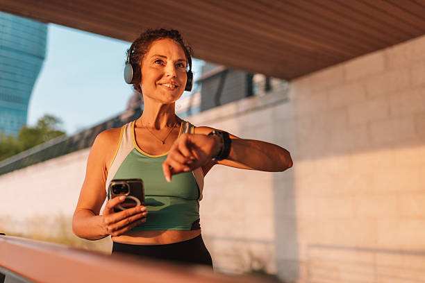 istock Smiling woman checks time during her workout routine. 2222267909