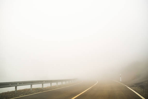 istock Mountain road in fog 2222268137
