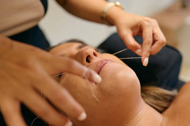 istock Beautician performing threading hair removal on upper lip 2222271531