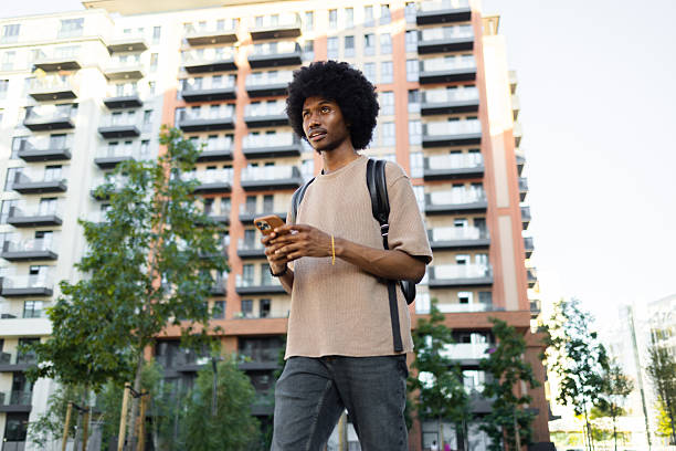 istock Young student walking in the city using a smartphone 2222272497