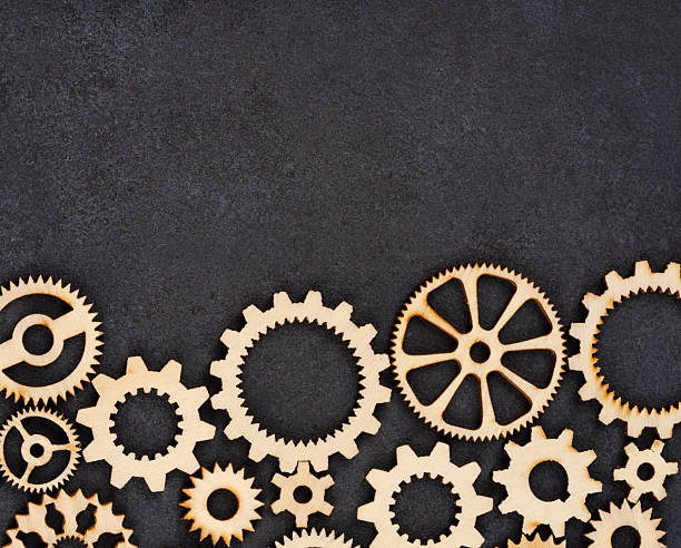 istock Wooden cogwheels on black background 2222275692