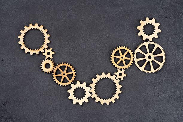 istock Wooden cogwheels on black background 2222275713