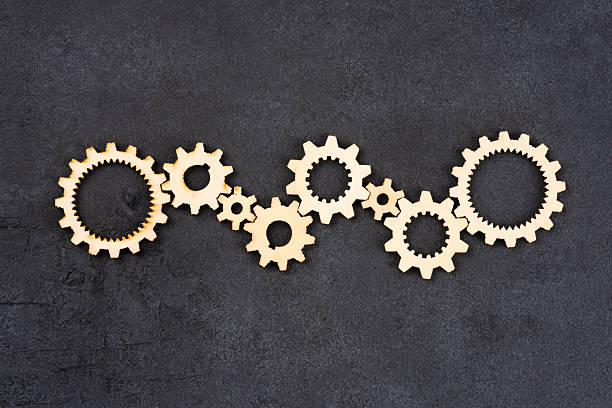 istock Wooden cogwheels on black background 2222275759