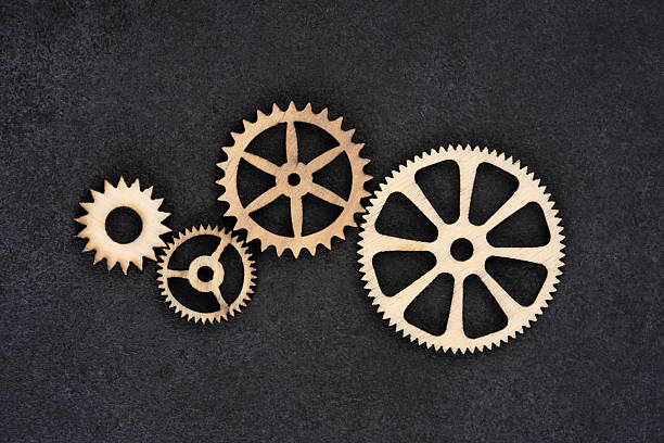 istock Wooden cogwheels on black background 2222275805