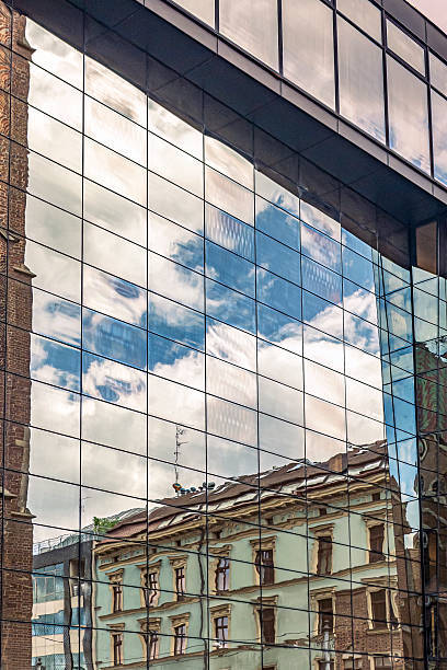 istock Modern Building Reflecting Old Architecture and Blue Sky in Glass Windows 2222276277