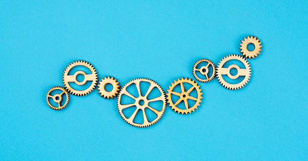 istock Wooden cogwheels on blue background 2222276358