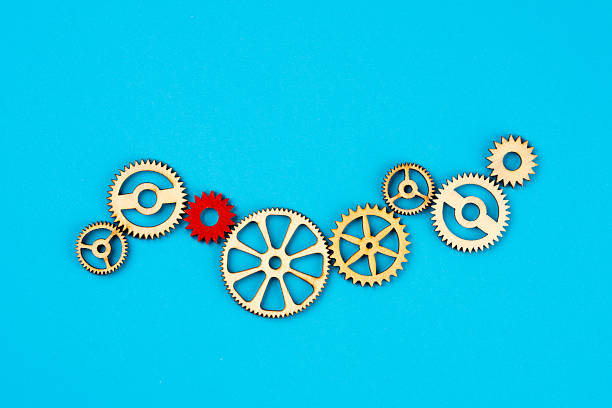 istock Wooden cogwheels on blue background 2222276458